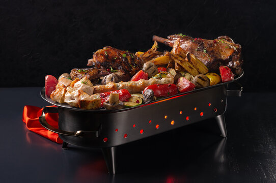 Assorted grilled meats: beef, pork, poultry, lamb. Juicy slices of meat delicacies. Food for a big company, a picnic.