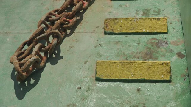 Old maritime artifacts. Ancient ship remnants showing age. Weathered nautical relics with faded paint surfaces. Corroded historical maritime objects with stained and worn surfaces clearly visible