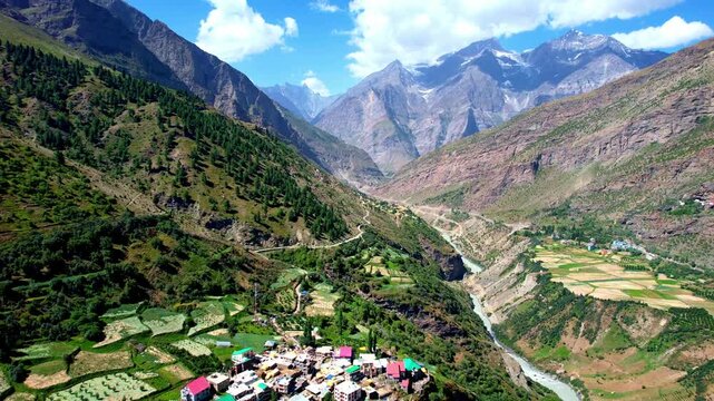 Scenic Rural Landscape With River. Vast Countryside With High Peaks And Vibrant Farmland Patches