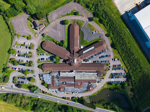 Aerial view of the Triumph Motorcycles factory building with its unique fan-shaped architecture and surrounding parking lots Hinckley, England, United Kingdom.