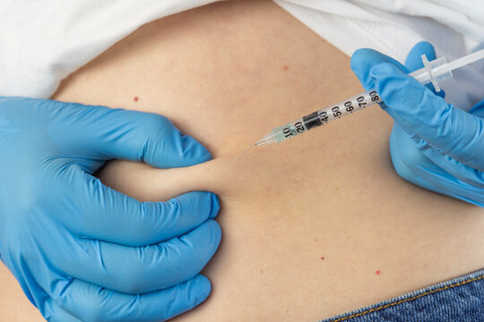 ghk cu peptide injection subcutaneous belly fold syringe hands analog ingredients therapy close up view looking away concept of cosmetology, biochemistry, pharmacology