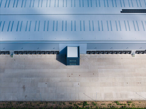 Aerial view of a large industrial warehouse with corrugated roofing and multiple loading docks Hinckley, England, United Kingdom.
