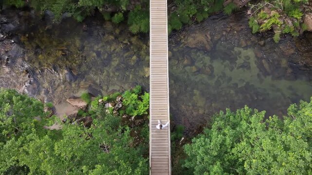 Suspension bridge connecting forest banks over the lerez river in galicia, spain
