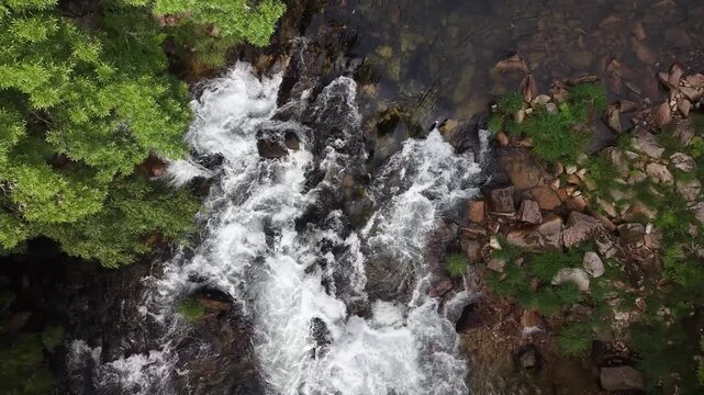 Rio lerez river flowing over rocks surrounded by lush green trees and vegetation