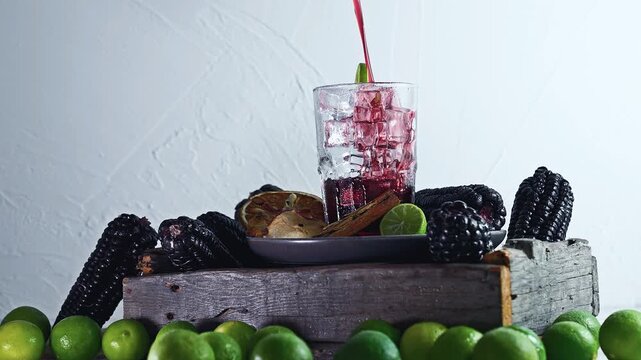 Pouring Chicha Morada, Purple Corn Drink with Lime and Cinnamon