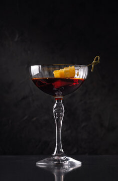 Martini - Rosso, cocktail drink with orange on minimalistic background. On a dark stone background