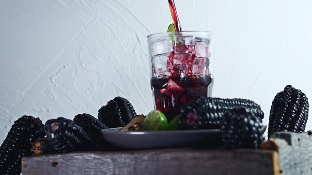 Pouring Chicha Morada, Purple Corn Drink with Lime and Cinnamon
