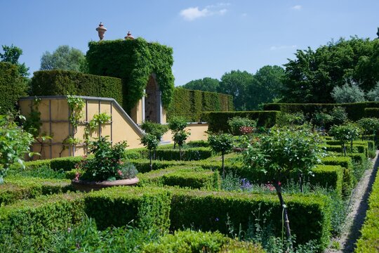 Formal garden with boxwood parterre hedges roses and tall hedge walls at Gardens of the World Berlin