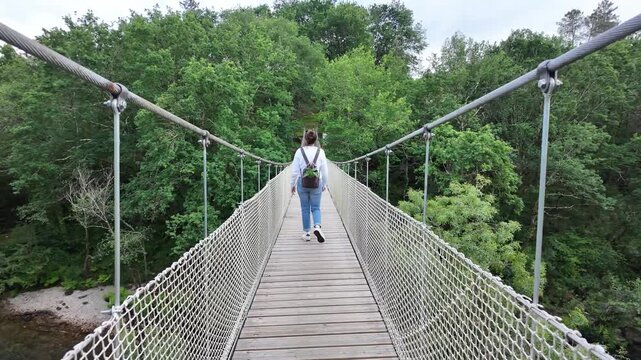 Suspension bridge connecting forest banks over the lerez river in galicia, spain