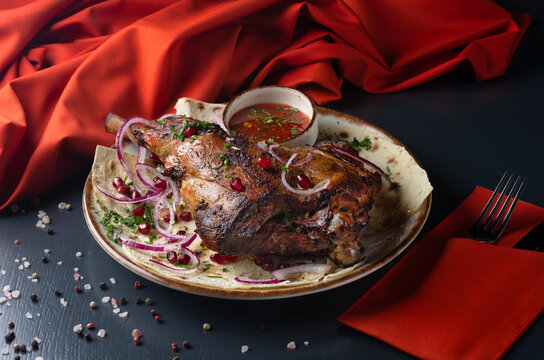 Grilled Shoulder of Lamb On a dark background. Menu for a Georgian restaurant. Restaurant menu