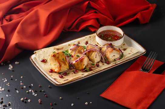 Kebabs - grilled meat skewers, shish kebab On a dark background. Menu for a Georgian restaurant.