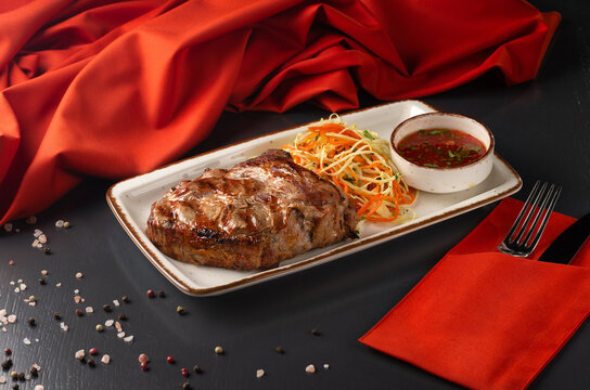 Grilled pork steak on a dark background. Georgian restaurant. Restaurant menu