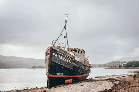 Abandoned shipwreck on the shore of a loch, Scottish Highlands