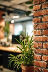 Naklejka premium Potted plant in front of classic exposed red brick wall