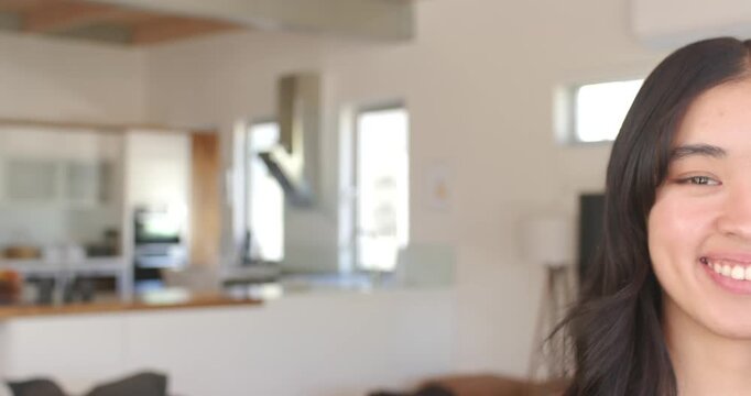 African American woman reacting to offscreen prompt, smiling, laughing in kitchen bar, copy space