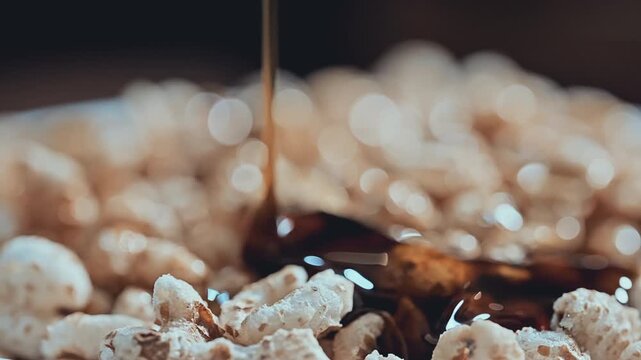 Extreme Macro of Colorful Cereal and Golden Syrup Pouring