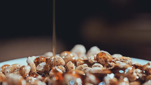 Extreme Macro of Colorful Cereal and Golden Syrup Pouring