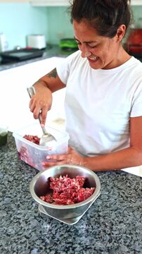 Woman preparing a raw BARF diet for a pet