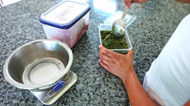 Person preparing raw BARF dog food in the kitchen