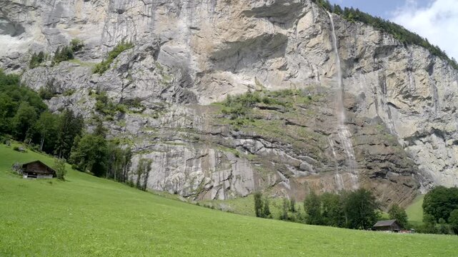 Lauterbrunnen Waterfall And Swiss Chalets - Smooth Walking Shot In Switzerland