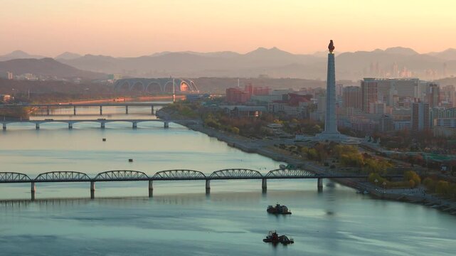 Juche Tower, Pyongyang morning panoramic view, North Korea. Taedong River in the morning fog. View facing upstream, modern residential complex. View from Yanggakdo Hotel