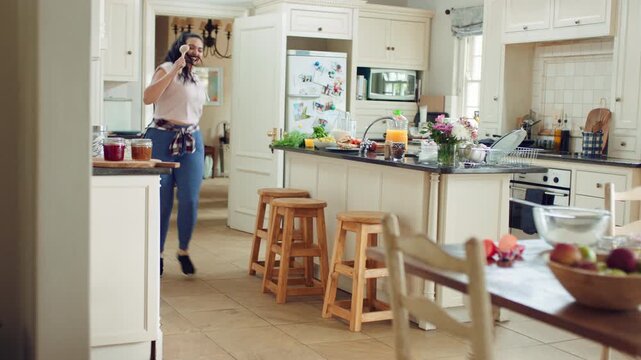 Dancing, woman and spin with spoon in kitchen, meal prep and moving with energy on weekend or goofy. Happy person, singing and stress free with rhythm, cooking and celebration for success in house