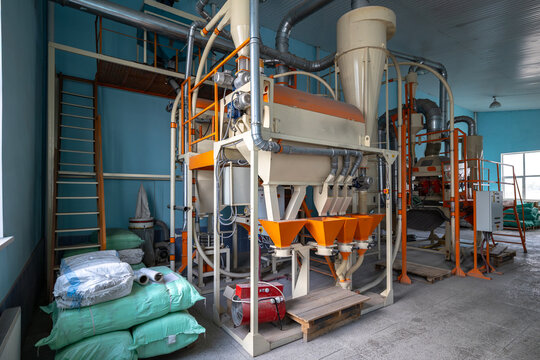 A large industrial aggregate unit for groats enrichment and grain purification stands inside an agricultural processing facility built to refine millet, corn groats, and small-seeded crops