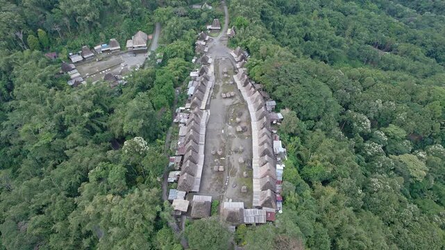 Aerial view of the Bena Traditional Village featuring historic thatched roof houses surrounded by dense tropical forest Kecamatan Jerebuu, Nusa Tenggara Timur, Indonesia.