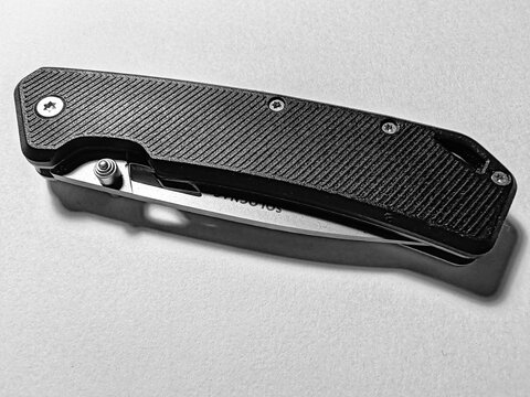 Rome, Italy - December 10, 2025, detail of a Solognac 8.5 cm folding knife with black V2 handle. This elegantly designed folding knife features an 8.5 cm blade.