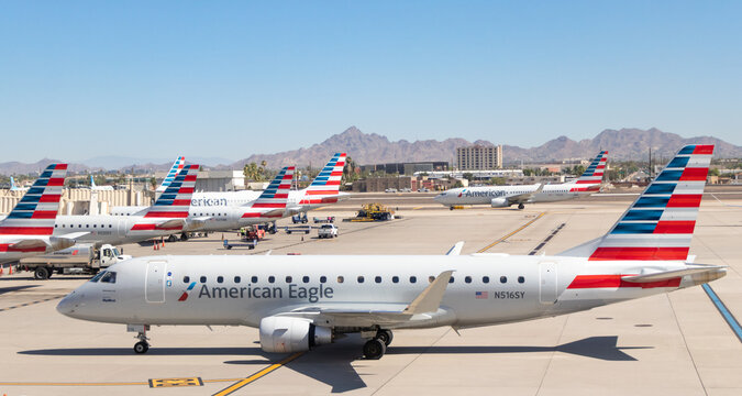 An American Airlines (American Eagle / Skywest) Embraer 175 and other American Airlines aircraft at Phoenix Sky Harbor International Airport - Phoenix, Arizona, USA