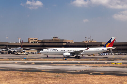 A Philippine Airlines Airbus A330 on taxiway with Terminal 1 in the background at Ninoy Aquino International Airport - Manila, Philippines