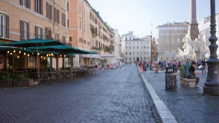 Fototapeta premium Blurred outdoor city square with cobblestone paving, cafe terraces and distant fountain rendered in shallow bokeh plaza; background backdrop copyspace calm.