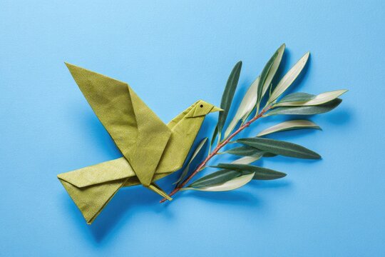 Origami dove with olive branch on blue background symbolizing peace