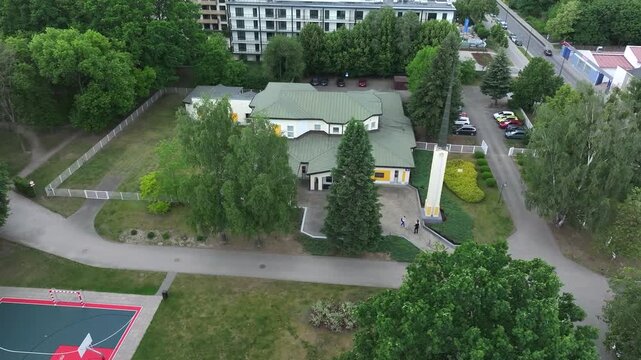 Aerial LDS Church Warsaw Poland circle 2 4K. Chapel the Church of Jesus Christ of Latter-day Saints. City center park. Religious headquarters. Royal Capital City of Warsaw in northern Poland.