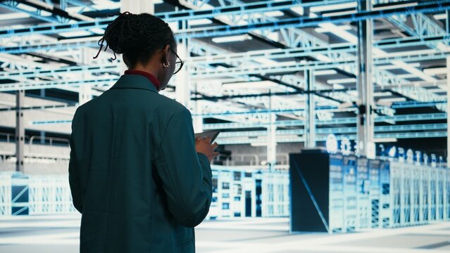 Writing code, tablet and female programmer walking in data center, compiling software patches, Running programming script, device application and African American woman in server hub, camera A.