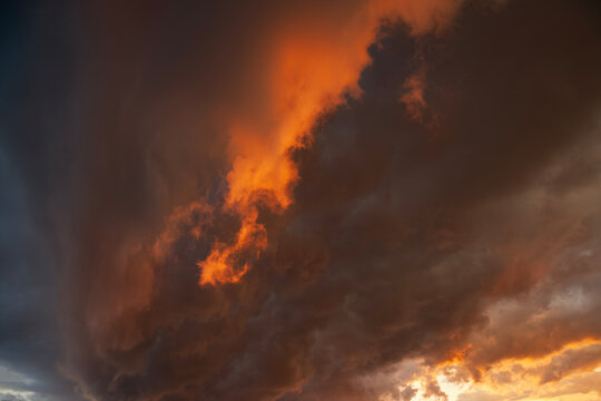 Fiery dark and dramatic storm clouds on a summer evening