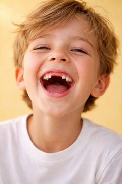 Happy young boy laughing with joy and showing his teeth