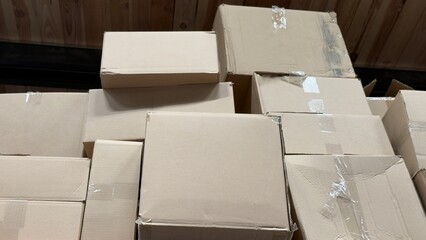 Fototapeta premium Stack of cardboard boxes for moving, empty brown paper packages for shipping and delivery concept