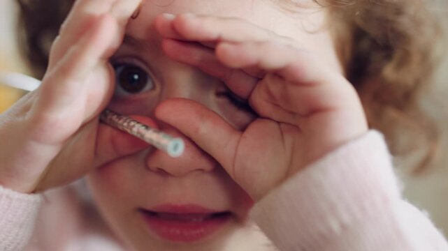 Face, hands and child with hide in home for peeking game, curious imagination and development. Wand toy, kid POV and happy with peekaboo in house for shy expression, innocent wonder and pretend play