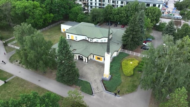 Aerial LDS Church Warsaw Poland slide 4K. Chapel the Church of Jesus Christ of Latter-day Saints. City center park. Religious headquarters. Royal Capital City of Warsaw in northern Poland.