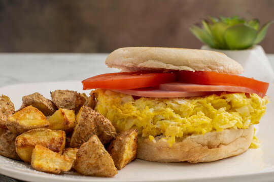 scramble egg and ham sandwich with  a side of home fries