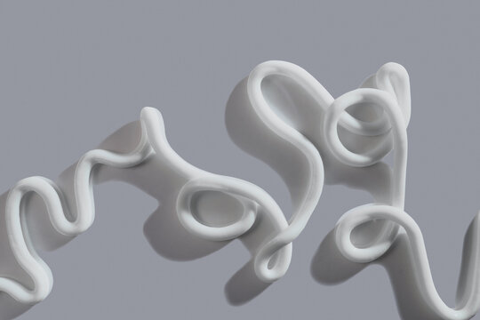 White cosmetic cream lines creating fluid texture on soft gray background