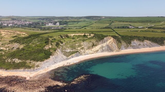 Aerial drone footage of Redcliff Point on the Dorset coast, showcasing striking coastal cliffs, rugged shoreline, and panoramic views of the English Channel