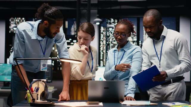 Diverse men and women working together on project in corporate space, collaborating on business intel data research. Coworkers brainstorming ideas, managing assignments for strategic goals.