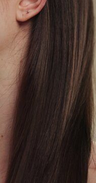 Hands, cosmetics and woman with brush for haircare, healthy growth and split ends removal. Self care, routine and person with hairbrush on closeup for beauty, scalp stimulation and style maintenance
