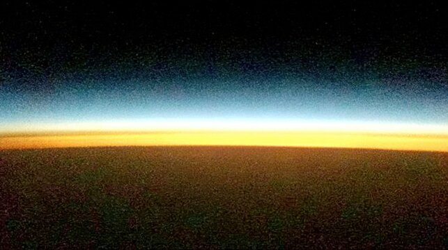 Aerial view of Earths horizon at sunset with atmospheric layers.