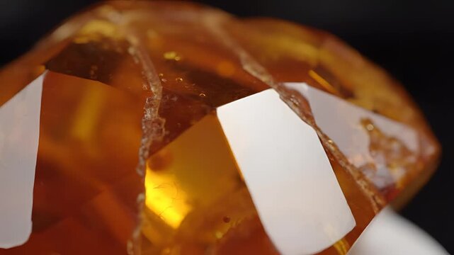 Macro Shot of a Sparkling Orange Crystal with Sharp Facets.
