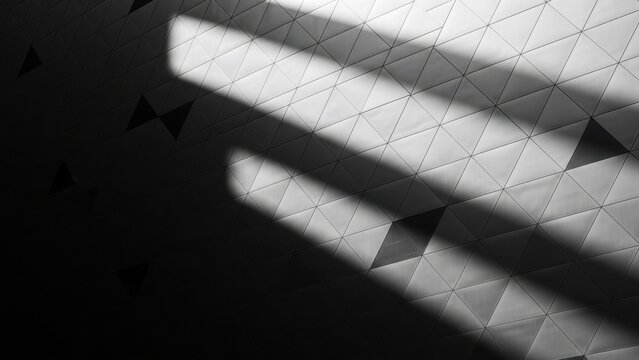 Black and white abstract architectural photo of triangular panels with dramatic shadows.