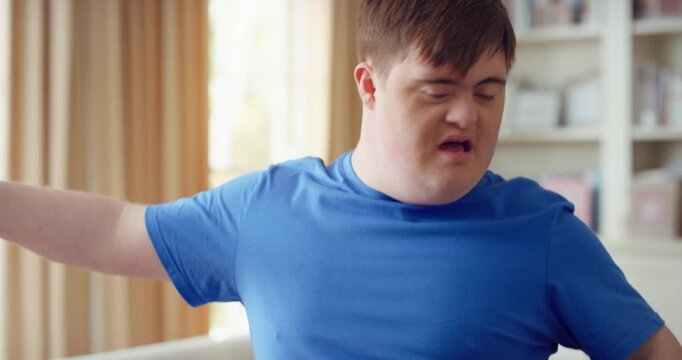 Man, dancing and active in lounge, rhythm and moving with energy and celebration on university break. Happy, home and person with down syndrome, excited and student with smile on weekend, fun or cap