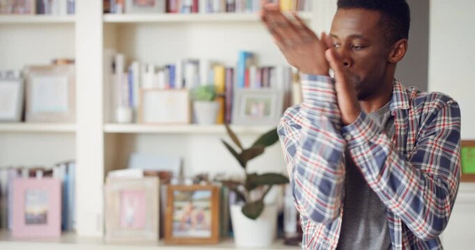 Dancing, hip hop and black man in home with energy, rhythm or movement to playlist on weekend. Happy, groove and African male person listening to music with choreography in living room at house.